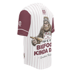 Baseball jersey with a cartoon Sasquatch holding a pie and text on a white background
