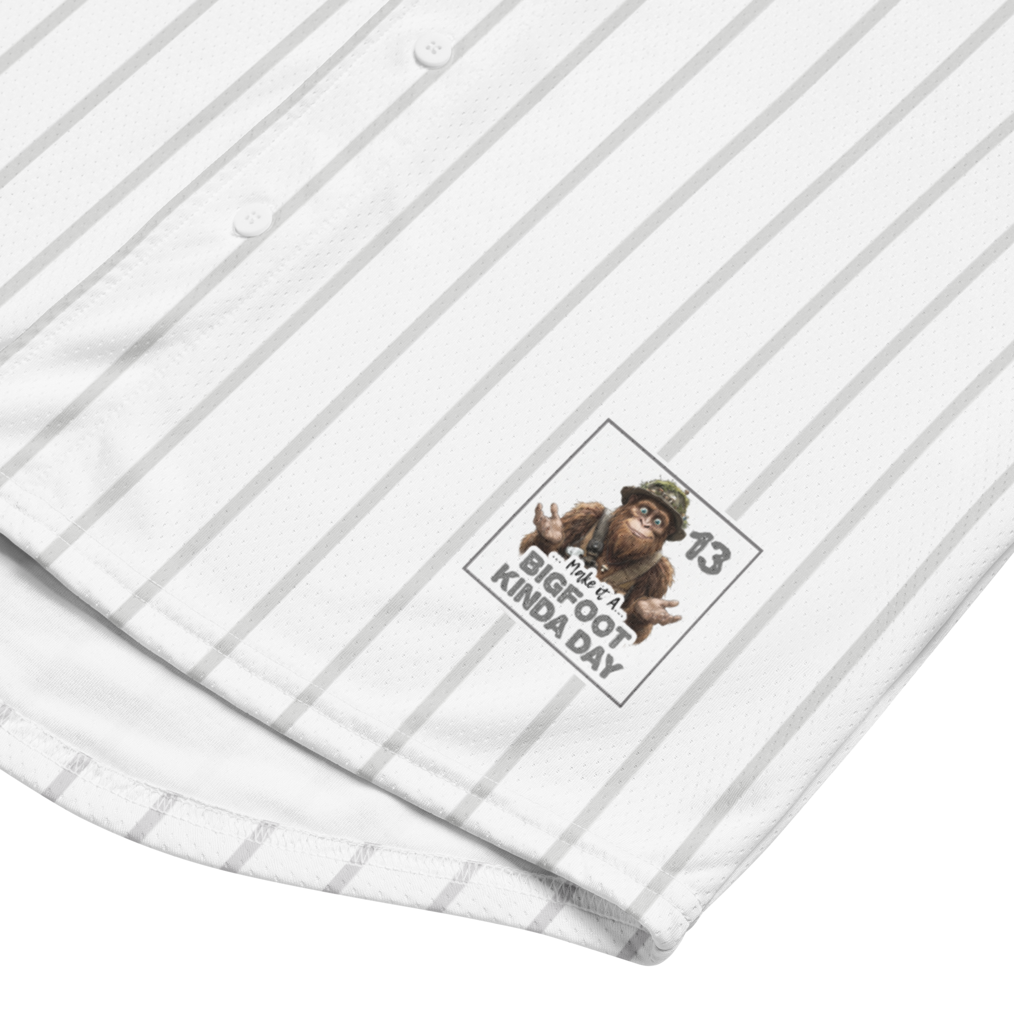 White shirt with yellow pinstripes and a logo featuring a monkey and text on a white background