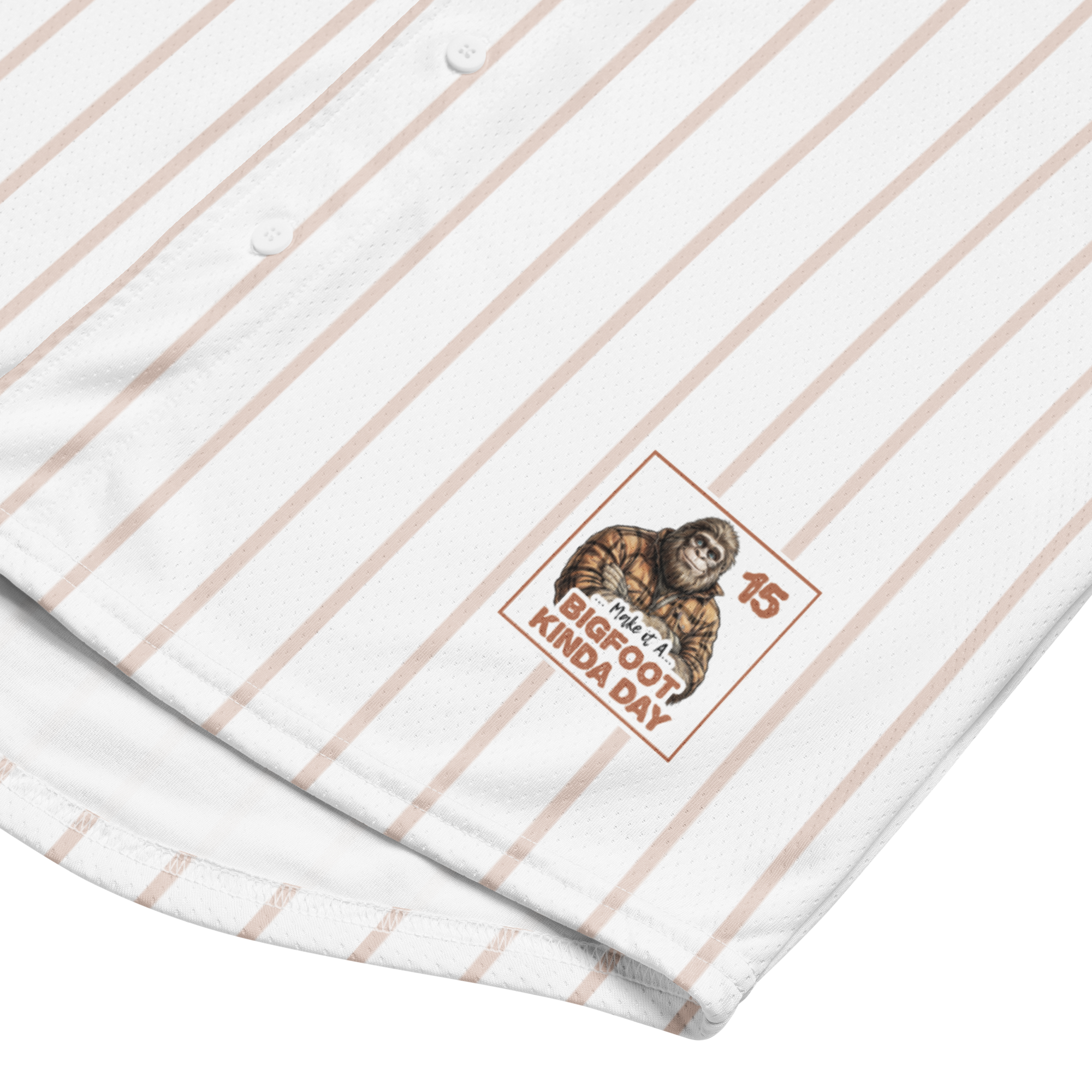 Close-up of a white shirt with brown pinstripes and a logo featuring a monkey and text.