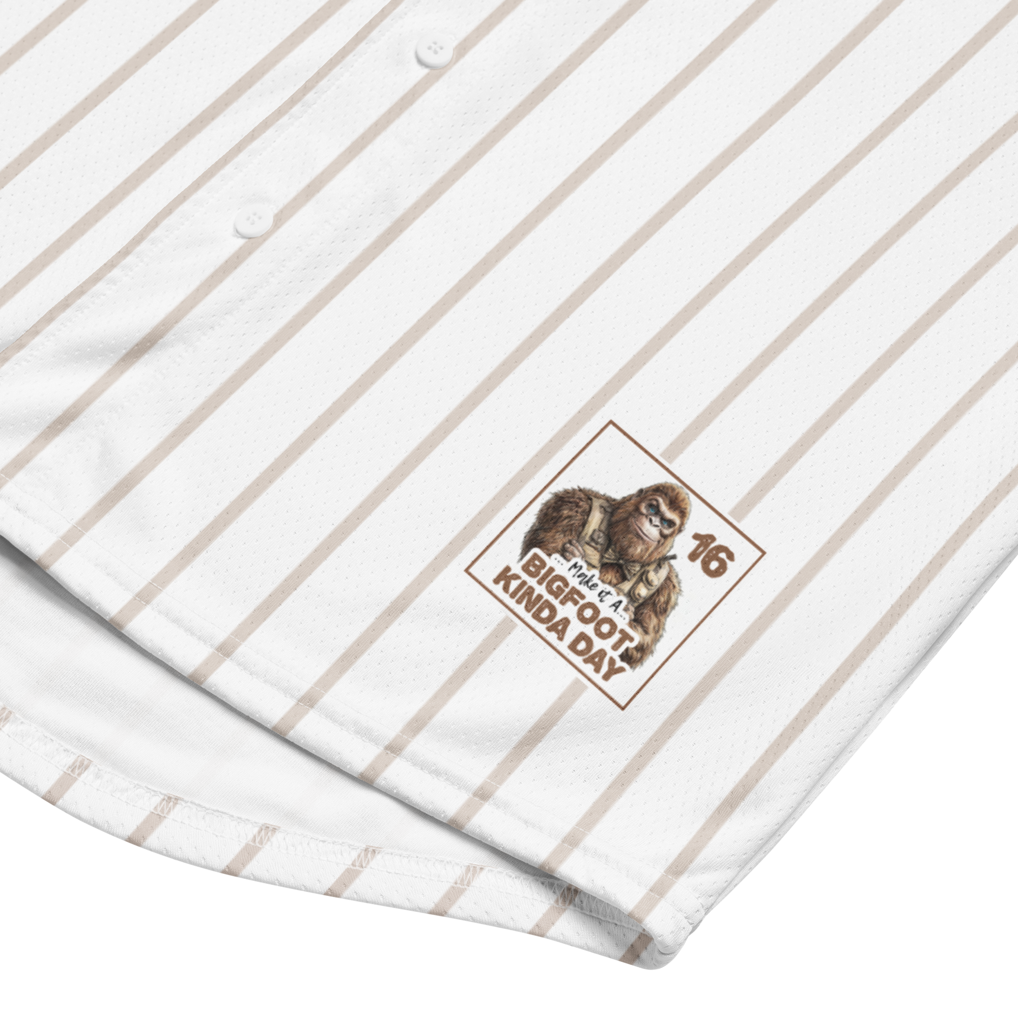 Close-up of a white shirt with brown pinstripes and a logo featuring a monkey and text.
